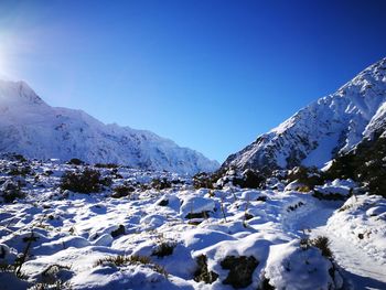 Scenic view of snowcapped mountains against blue sky