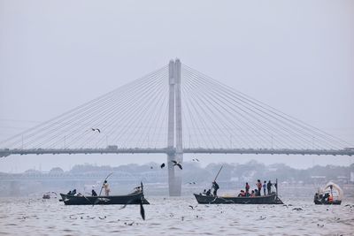 People on boat against sky