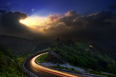 High angle view of road amidst mountains against sky during sunset