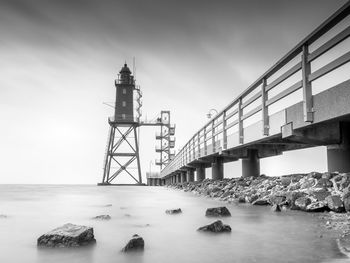 Bridge over sea against sky