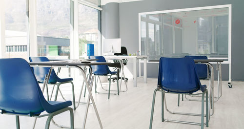 Empty chairs and tables in cafe