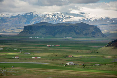 Scenic view of field and mountains against sky