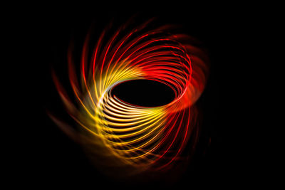 Abstract image of illuminated light over black background