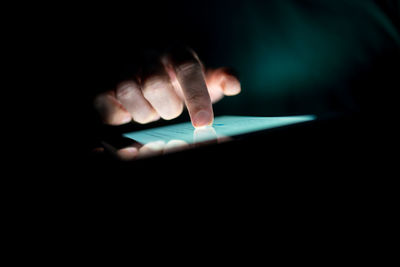 Close-up of hand using digital tablet