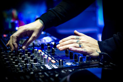 Midsection of man using sound mixer