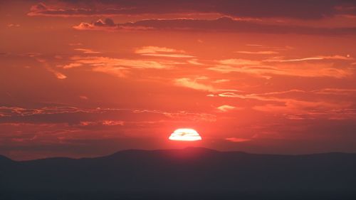 Scenic view of silhouette landscape against romantic sky at sunset