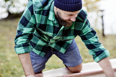 Midsection of man standing in hat