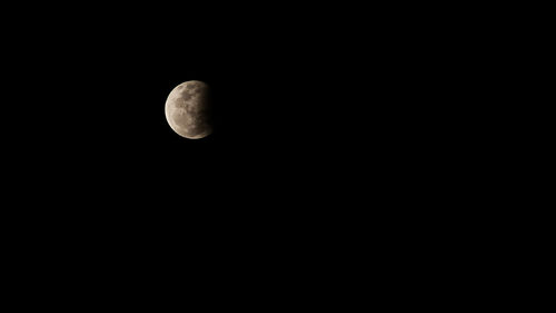 Low angle view of moon against sky at night