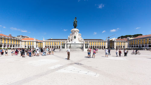 People at praca do comercio against sky