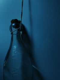 Close-up of water bottle against blue background