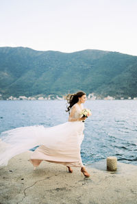 Side view of woman looking at sea