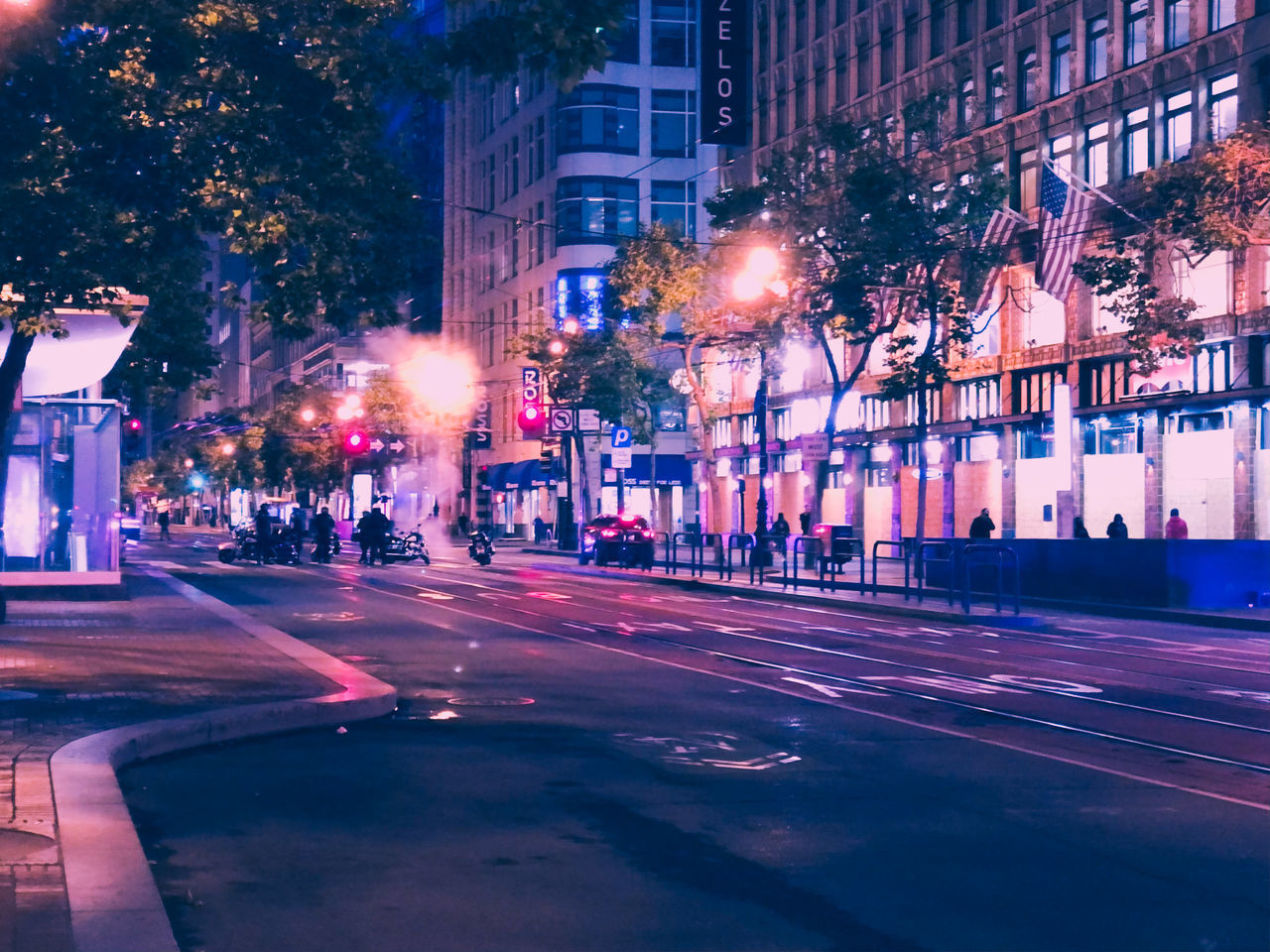 VIEW OF CITY STREET AND BUILDINGS AT NIGHT