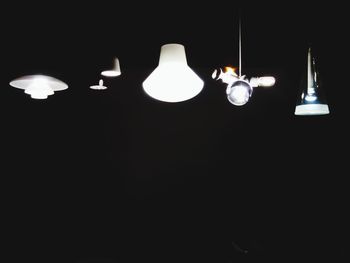 Low angle view of lit lamp in the dark