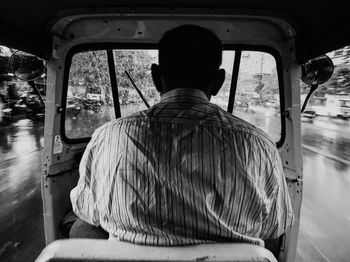 Rear view of man sitting in bus