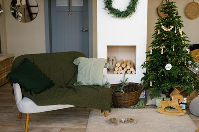 Stylish christmas decor in a scandinavian country house in beige tones. fireplace and christmas tree