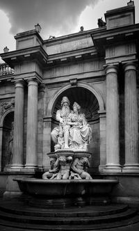 Low angle view of statue against historic building