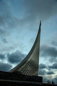 Low angle view of modern building against cloudy sky