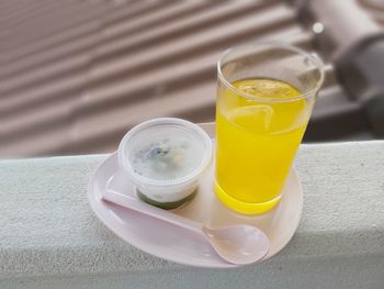High angle view of yellow and drink on table