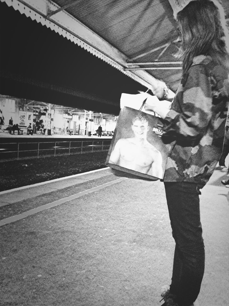 REAR VIEW OF MAN WALKING IN UNDERGROUND WALKWAY