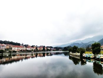 Calm lake with houses in background