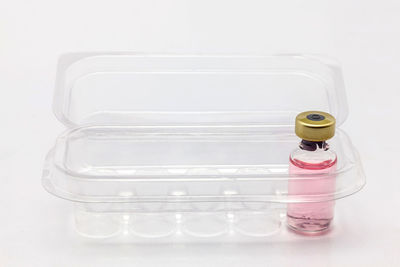 High angle view of bottles on table against white background