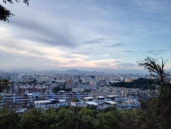 Cityscape against cloudy sky