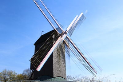 Low angle view of traditional windmill against sky