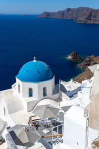 Beautiful view of oia town in santorini island with whitewashed churches with blue roof, greece