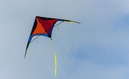 Low angle view of colorful kite flying against sky