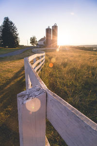 Built structure on field against sky during sunset