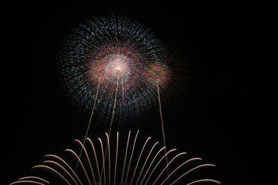 Low angle view of firework display at night