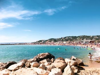 Scenic view of rocks on beach against sky