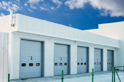 Car repair station against a blue sky with clouds