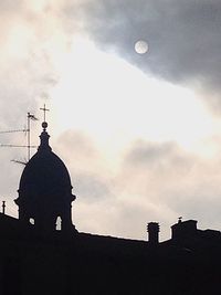 Low angle view of church against cloudy sky