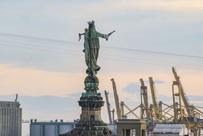 Low angle view of statue against cloudy sky