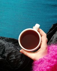 Close-up of hand holding tea cup