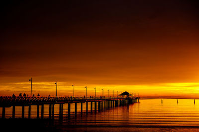 Jetty shadows against a firey first light sky