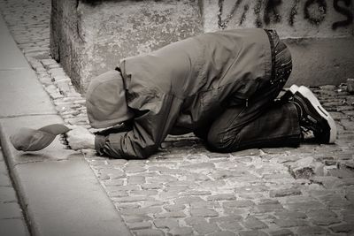 Man sleeping on footpath