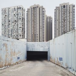 Street amidst buildings against sky in city