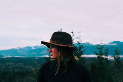 Woman standing on field against sky