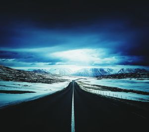Panoramic view of snow covered road against sky