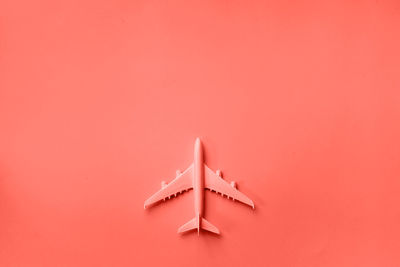 Directly above shot of toy on pink table against red background