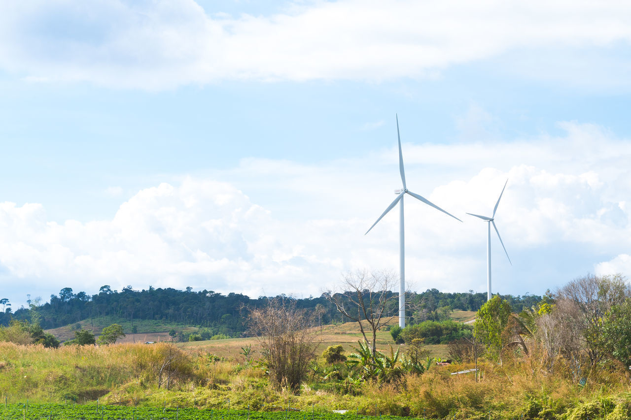 WIND TURBINES ON LAND AGAINST SKY