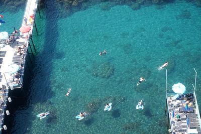 High angle view of people swimming in sea