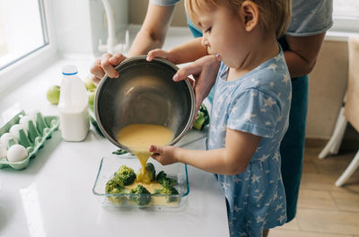 Midsection of woman preparing food in kitchen