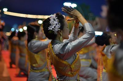 Rear view of people dancing at night