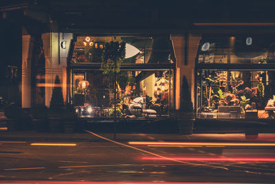 View of illuminated shop at night