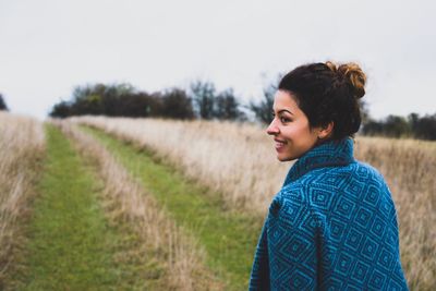 Woman standing on grassy field