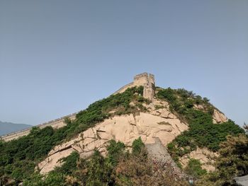 Low angle view of castle on mountain against sky