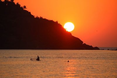 Scenic view of sea and mountains during sunset